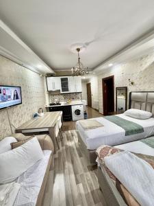a hotel room with two beds and a kitchen at Ayasofya Lıfe Suıte in Istanbul