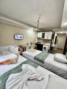 a hotel room with two beds and a kitchen at Ayasofya Lıfe Suıte in Istanbul