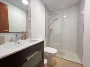 a bathroom with a sink and a toilet and a shower at Suites Esencia Atlántica Confort cerca del mar in Telde