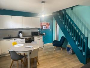 a kitchen and dining room with a table and a staircase at Opale d 'Etaples in Étaples