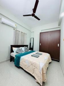 a bedroom with a bed and a ceiling fan at Parkview Escape 1BHK Penthouse In Kondapur in Hyderabad