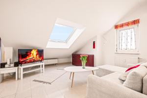 a living room with a couch and a tv at BERGblume im Zentrum inkl. Staufen PLUS in Oberstaufen