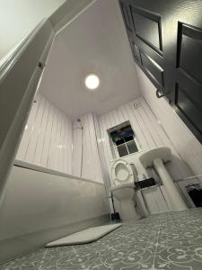 a bathroom with a toilet in a small room at Home away Tamworth Staffordshire 4 Bedroom 3 Bathroom - Semi Detached House in Glascote