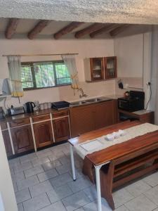 a kitchen with a wooden table in a room at Hibberdene Cottage Crew in Hibberdene