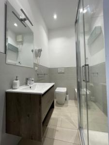 a bathroom with a sink and a toilet and a shower at Oasis in Acitrezza
