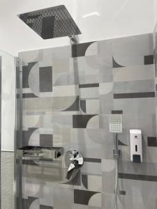 a bathroom with a shower with a shower head at Oasis in Acitrezza