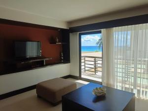 a living room with a view of the beach at Awesome apartment at Aldea Thai Beachfront in Playa del Carmen