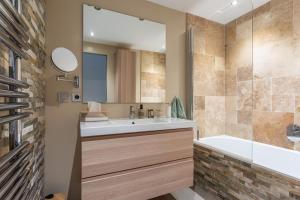a bathroom with a tub and a sink and a shower at Maison Sainte Maxime in Le Plan +19 photos