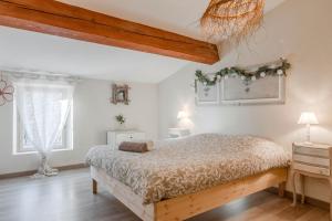 a bedroom with a large bed and two windows at Maison Sainte Maxime in Le Plan