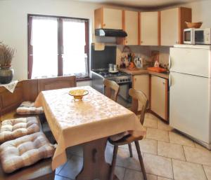 a kitchen with a table and a white refrigerator at Welcoming apartment in Medulin - 75 sqm with view in Medulin