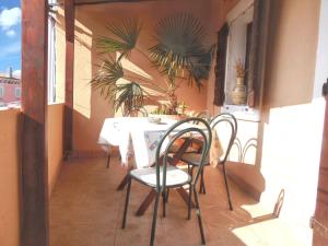 a table and chairs on the balcony of a building at Welcoming apartment in Medulin - 75 sqm with view in Medulin