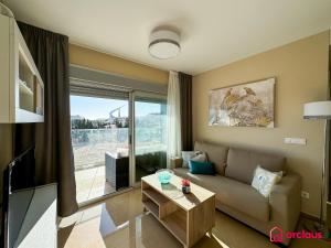 a living room with a couch and a large window at Brisa Azul in Cabanes