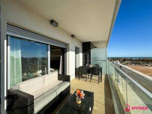 a living room with a couch and a table on a balcony at Brisa Azul in Cabanes +47 photos