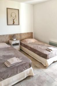 two beds sitting in a room with at Villa avec piscine à Saint-Florent - 350 m² vue mer et montagne in Saint-Florent