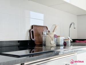 a kitchen counter with a sink with utensils at Brisa Azul in Cabanes