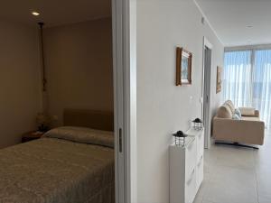 a bedroom with a bed and a couch and a window at Seaside Resort in Trieste