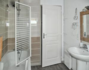 a white bathroom with a shower and a sink at Maison spacieuse près de Gérardmer avec vue sur le lac in Gérardmer +33 photos