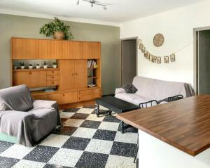 a living room with a couch and a table at Maison accueillante à Orgnac-l'Aven avec piscine partagée in Orgnac-lʼAven