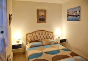a bedroom with a bed with two lamps on it at Maison charmante à Vaux-sur-Mer avec piscine partagée in Vaux-sur-Mer