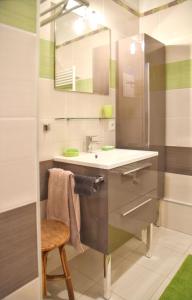 a bathroom with a sink and a mirror at Maison charmante à Vaux-sur-Mer avec piscine partagée in Vaux-sur-Mer +52 photos