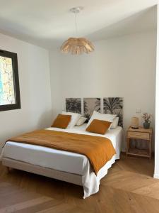 a bedroom with a large bed with a brown blanket at Casa Raphael in Ajaccio