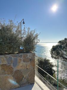a stone wall with a view of the ocean at Seaside Resort in Trieste