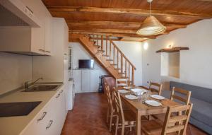 a kitchen and dining room with a table and chairs at Casa Del Borgo in Motta San Giovanni