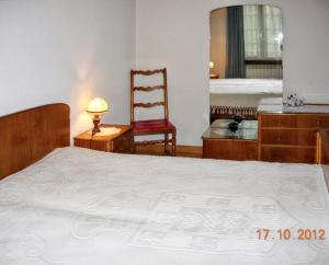 a bedroom with a bed and a chair and a desk at Comfortable house with mountain view and shared pool in Pedraça +19 photos
