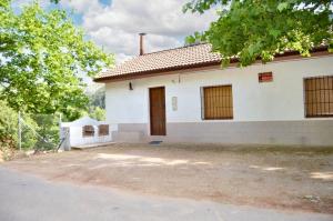 a white house with a fence in front of it at Charming house with mountain view in Siles + Garden in Siles