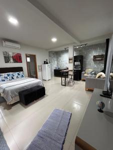 a bedroom with a bed and a living room at Casa Copacabana 2 in Urubici