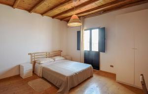 a bedroom with a bed and a large window at Casa Del Borgo in Motta San Giovanni