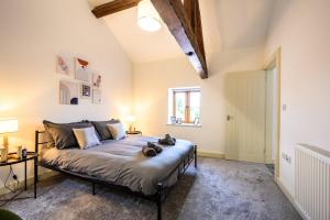 a bedroom with a bed in a room at Bluebell Barn I Hot Tub I Games Room I Pets Welcome in Preesgreen
