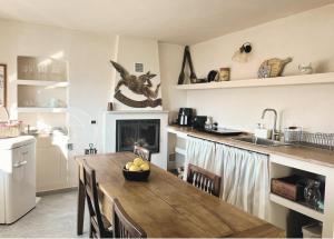 a kitchen with a table with a bowl of fruit on it at Casa Rosalinda, Monferrato cozy apartment in Camino