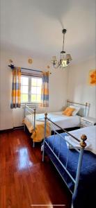 a bedroom with two bunk beds and a window at Casa Terraço in São Bernardino