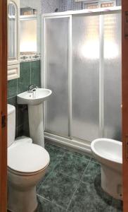 a bathroom with a toilet and a sink and a shower at Spacious Apartment in Barbate - Terrace with Sea View in Barbate