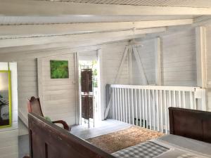 Postel nebo postele na pokoji v ubytování Appartement cosy au Carbet avec balcon et vue sur mer - 70 m²