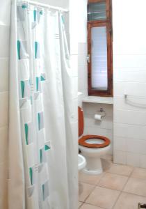 a bathroom with a toilet and a shower curtain at Charming Apartment in Massa Marittima, Shared Pool in Massa Marittima