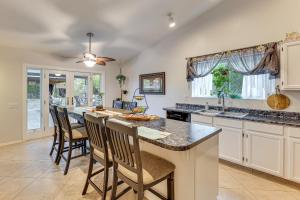 a kitchen with a large island with chairs around it at 4 Mi to Salt River Mesa Home with Private Patio in Mesa