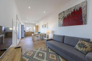 a living room with a couch and a table at AlmeriaSuite Cortijo Las Golondrinas in Mojácar