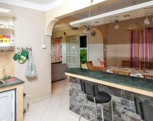 a kitchen with a counter with a bar stool at Paradisiacal Villa in Grand Baie with Private Pool in Grand Baie