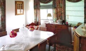 a kitchen with a table with two flowers on it at Charming house with sea view in Angra do Heroísmo in Angra do Heroísmo +22 photos