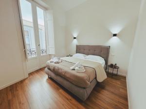 Un dormitorio con una cama grande y una ventana grande. en Candalù - Palermo Suite, en Palermo 24 fotos más