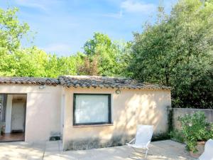 a house with two white chairs in front of it at Maison charmante proche de Barjols avec piscine privée in Barjols