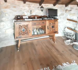 a wooden cabinet with a television on top of it at House with Shared Pool in Águeda, Mountain View in Urgueira