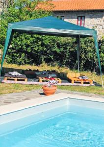 a blue canopy over a swimming pool in a yard at House with Shared Pool in Águeda, Mountain View in Urgueira +55 photos