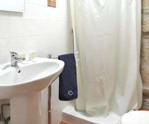 a white bathroom with a sink and a shower at Cozy house in Águeda 45 m² with shared pool in Urgueira +38 photos