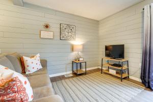 a living room with a couch and a television at Hike, Boat, Fish and More Table Rock Lake Cottage in Cape Fair