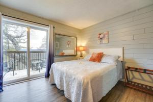 a bedroom with a bed and a large window at Hike, Boat, Fish and More Table Rock Lake Cottage in Cape Fair