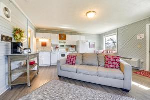 a living room with a couch and a kitchen at Lake Views and On-Site Hiking Cape Fair Cottage in Cape Fair