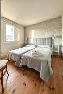 a bedroom with a large bed with two towels on it at Beautiful Holiday Home in Po de Llanes with Sea View in poo de Llanes